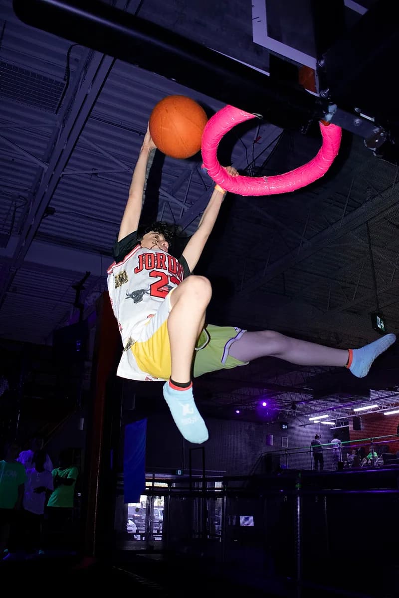 Kid jumping toward the Aero Hoops basketball attraction at AeroSports