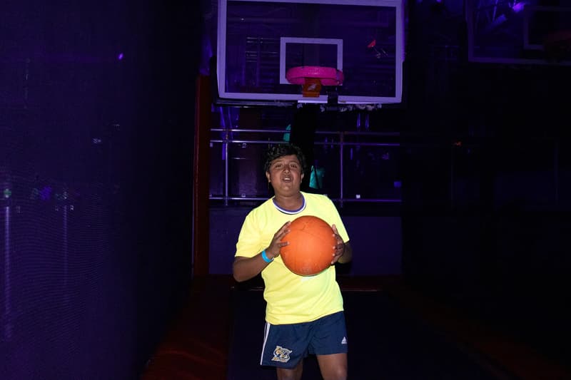 Kid jumping toward the Aero Hoops basketball attraction at AeroSports