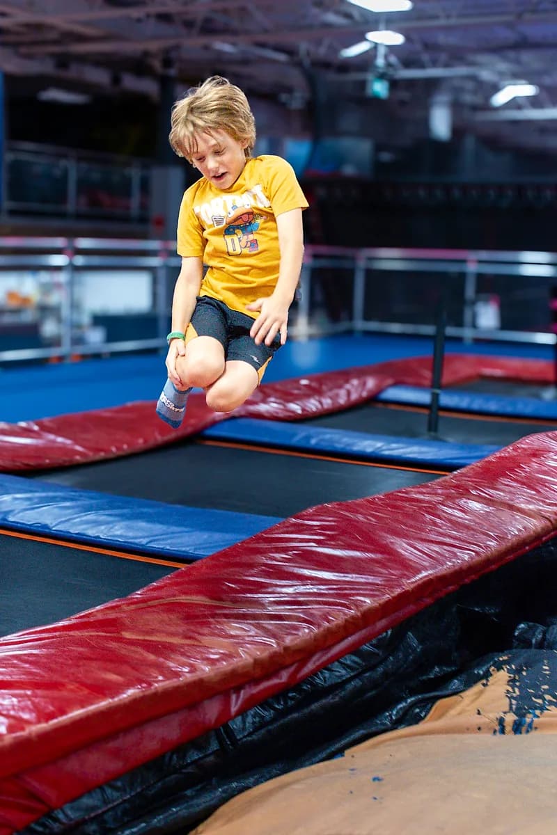 Child jumping onto the AeroSports air bag attraction
