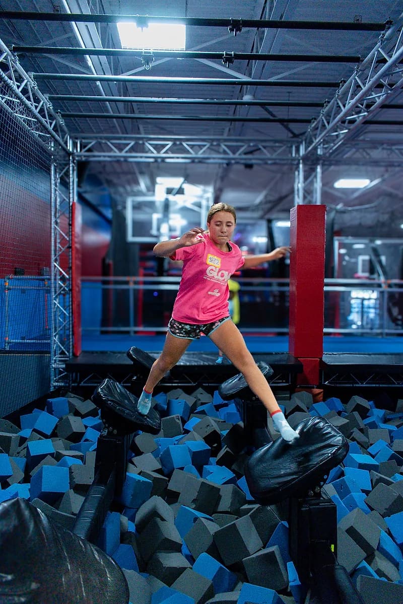 Kid taking on the Ninja Warrior obstacle course at AeroSports