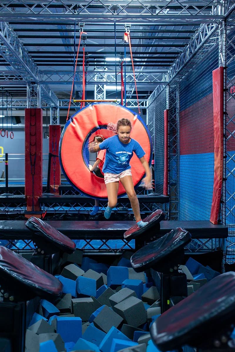 Kid taking on the Ninja Warrior obstacle course at AeroSports